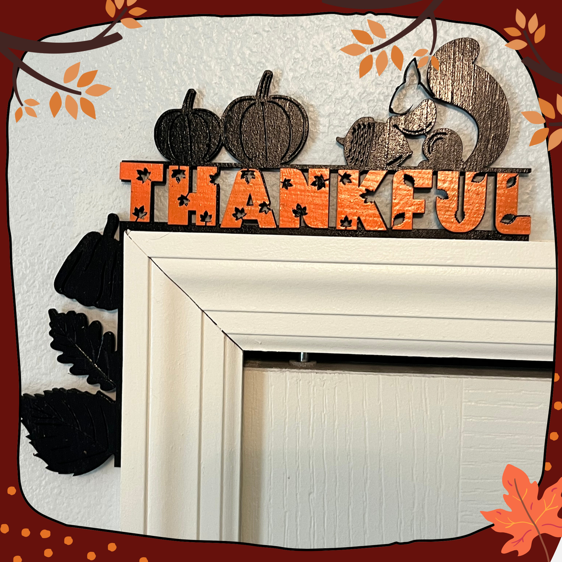 Autumn Decoration - Door Frame Decoration with a black base with leaves, pumpkins and a squirl along with a layered orange text that says &