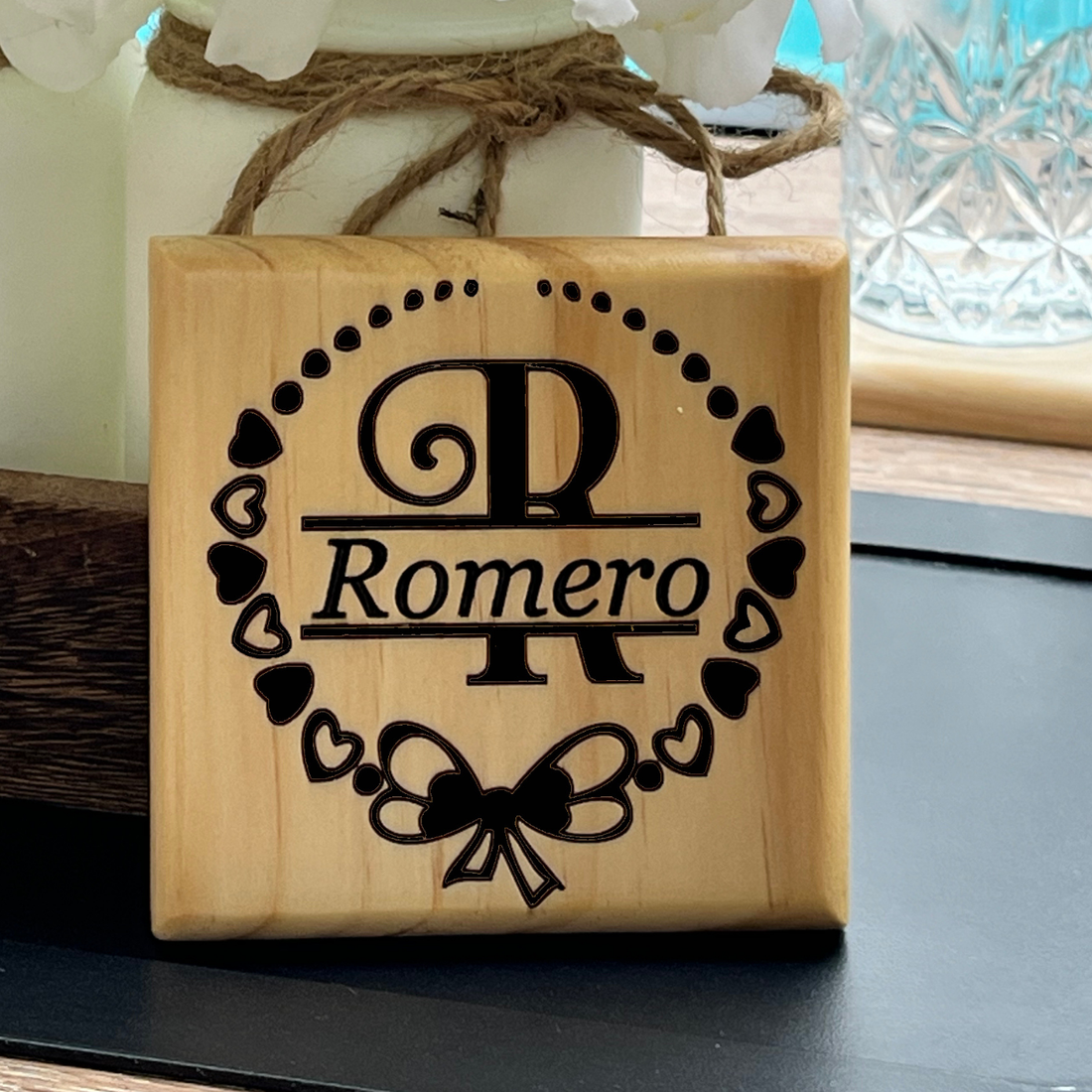 Custom made wooden cup coaster product image with personalized split monogram letter surrounded by a heart wreath